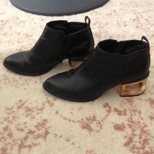 Black ankle bootie w/gold metal heel